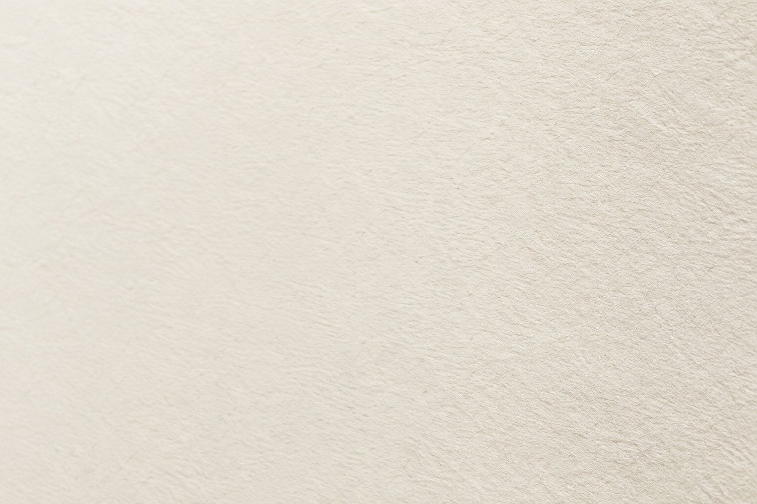 Overhead editorial close-up of the soft, matt surface of unprinted fine art paper